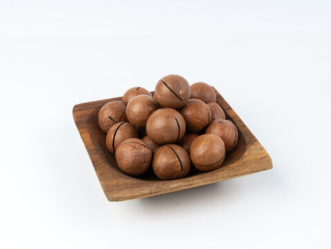 Macadamia nuts isolated. Natural raw peeled macadamia seeds and shells