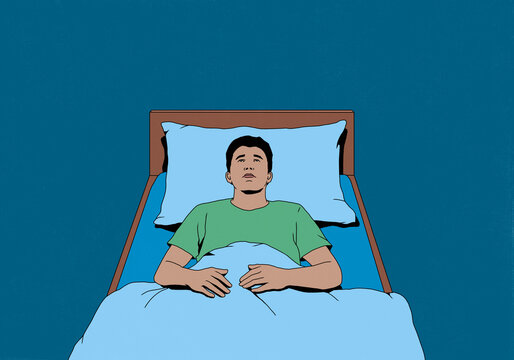 Man with insomnia laying in bed looking up at ceiling