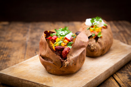 Sweet potato kumpir with chili con carne, sour cream and coriander