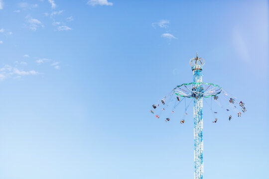 Germany, Bavaria, Munich, Low angle view of Bayern Tower chain swing ride standing against clear sky