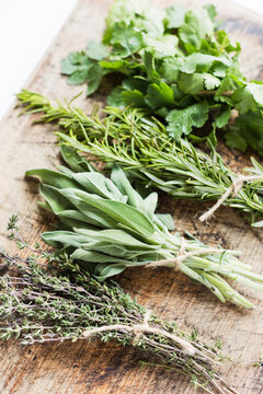 Bunch of fresh herbs on wooden table at home