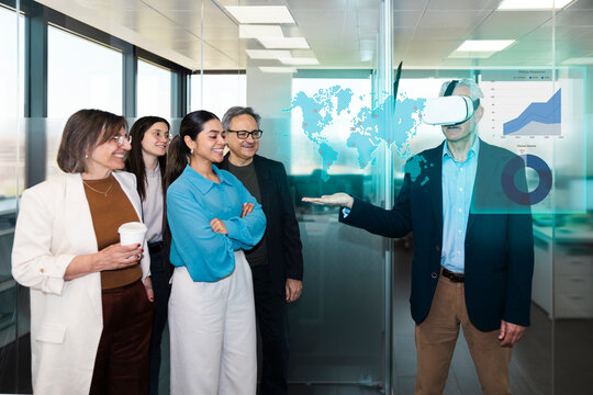 Business team watches a man using a virtual reality headset