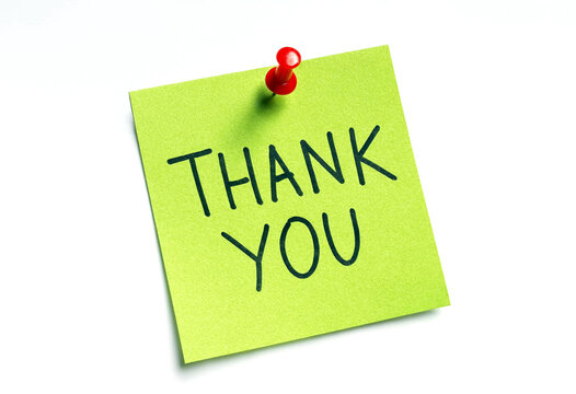 Bright green sticky note with thank you message pinned for appreciation expression