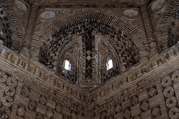 Ornate brick interior of Ismail Samani Mausoleum in Bukhara showing intricate geometric brickwork and squinches. Ideal for architecture, heritage, and travel publications. © finepoints