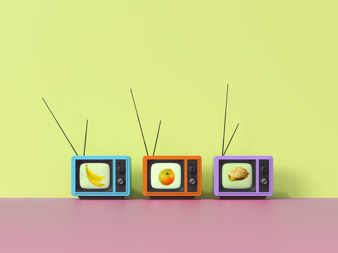 Three retro televisions broadcast healthy and fast food indoors