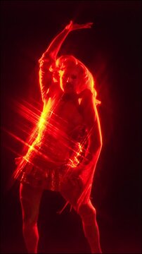 Fabulous drag queen dancing in a red spotlight
