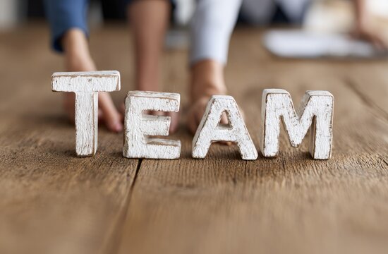 Teamwork Concept with People Hands Forming Word Team on Wooden Table