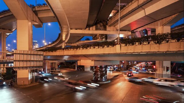 Asia, China, Shanghai, day to night cityscape time lapse of road intersection in central Shanghai, busy with rush hour traffic and commuters