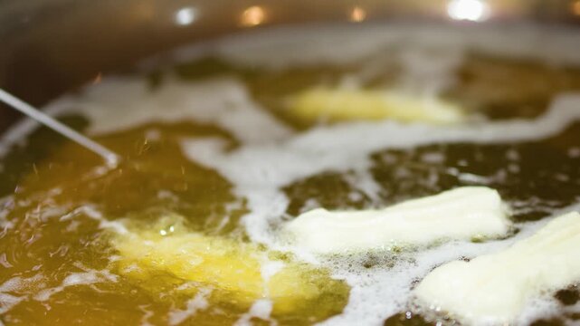 Chef Deep Frying Traditional Chinese Youtiao Doughnuts in Hot Oil