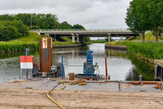 waterworks contractors barge with spud pile anchor system in Middenmeer Netherlands canal infrastructure and engineering construction maritime