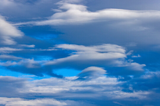 White lenticular clouds in afternoon