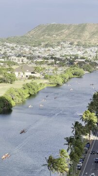 Outrigger boat or Canoe is a watercraft. Ala Wai Canal is an artificial waterway in Honolulu, Oahu, Hawaii. northern boundary of the tourist district of Waikiki. Coconut palm tree (Cocos nucifera)
