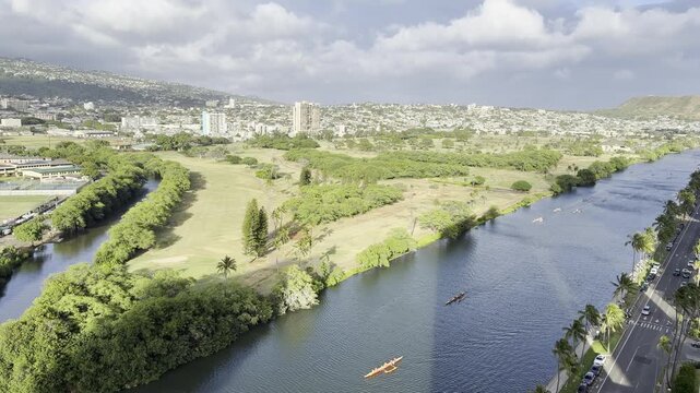 Outrigger boat or Canoe is a watercraft. Ala Wai Canal is an artificial waterway in Honolulu, Oahu, Hawaii. northern boundary of the tourist district of Waikiki. Coconut palm tree (Cocos nucifera)