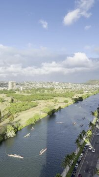 Outrigger boat or Canoe is a watercraft. Ala Wai Canal is an artificial waterway in Honolulu, Oahu, Hawaii. northern boundary of the tourist district of Waikiki. Coconut palm tree (Cocos nucifera)