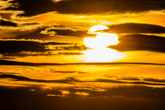 Golden sunset sky with dark clouds
