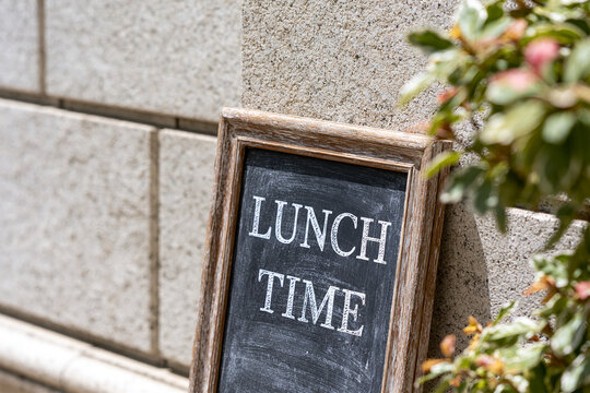 Rustic chalkboard sign reading LUNCH TIME outside a restaurant