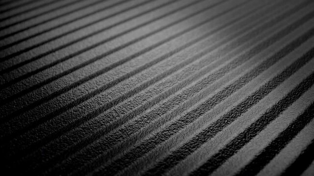 Dark Ribbed Rough Surface. Macro view of parallel raised grooves under directional light with slow camera movement. Suitable for abstract backgrounds.