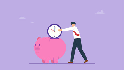 Success man holding big clock or watch put into pink saving piggy bank. Time is money, people pay money to buy time that most important for success in financial goals concept. © yedsgn