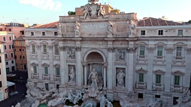 Trevi Fountain&rsquo;s entire baroque facade, statues, and water basin fill the frame from a steady elevated frontal angle.