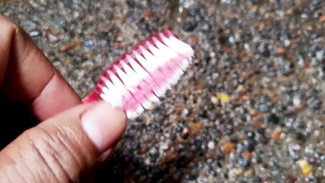Close up of old used toothbrush with frayed bristles, dental hygiene concept