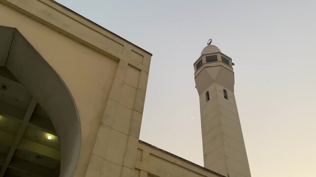 Baitul Mukarram National Mosque minaret with birds flying, Dhaka, Bangladesh.