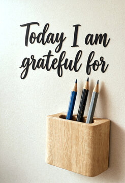 Wooden wall organizer with pencils and inspirational gratitude quote for daily motivation and positivity