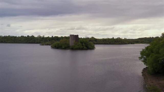 Aerial drone gliding slowly sideways framing picturesque Cloughoughter island castle, County Cavan Ireland