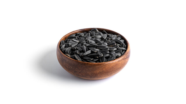 Sunflower seeds in a wooden bowl isolated on a white background. High quality photo