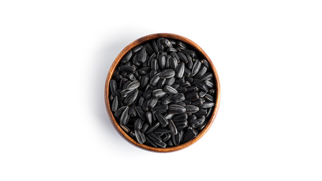 Sunflower seeds in a wooden bowl isolated on a white background. High quality photo