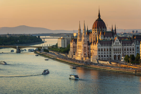 hungarian parliament building and danube river at sunset