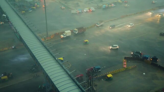 Heavy smog over Delhi NCR highway. Traffic moving through thick pollution in Noida area.
