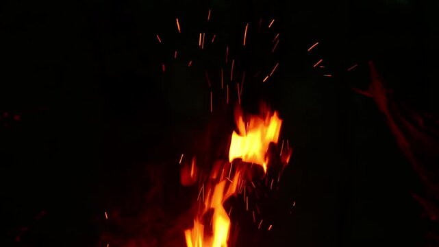 Seamless Loop of Fire Sparks Flying in Night Forest with Crackling Sound, Burning Campfire Embers, Glowing Particles VFX Overlay, Firewood Audio, Dark Background Ambient Footage.