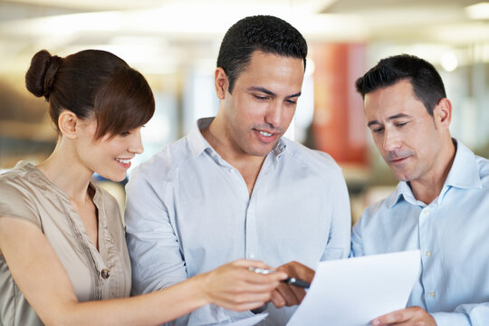 Business, team and advice with paperwork in office for article feedback, story review and guidance. People, copywriter and happy with documents for submission comments, writing tips and proofreading