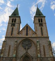 Obraz premium Sacred Heart Cathedral aka Sarajevo Cathedral with clocks and Blue Sky Background in Sarajevo, Bosnia and Herzegovina