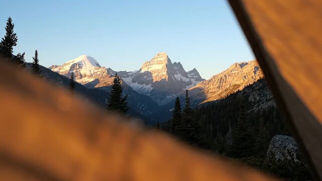 Close-up view of a water droplet on a brown fabric with blurred mountain peaks in the background during golden hour in a natural outdoor setting