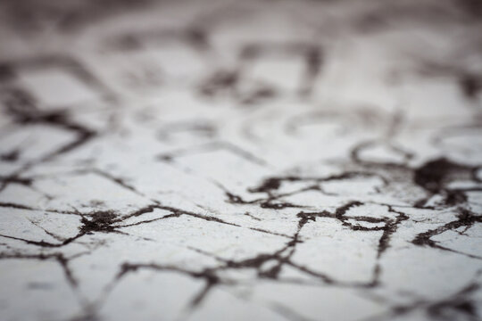Extreme close up of black acrylic paint texture on paper. Selective focus.