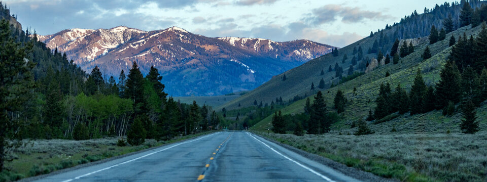 Empty highway 75 with mountains in distance at sunset