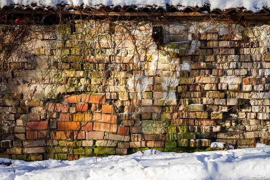 Old abandoned brick wall in winter. Architectural detail.