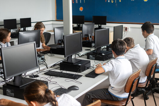 Elementary school students using desktop computers in computer lab