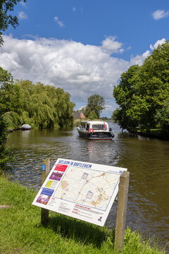 Canal boat passing famous crossing of the Frisian Eleven City Skating Tour in Bartlehiem, Friesland, Nethrlands