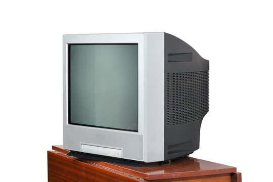 An old television sits on a vintage nightstand from the 1990s and 1980s against a white background.