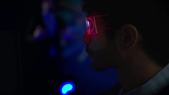Business executive wearing smart glasses analyzing digital dashboards and business intelligence metrics in a modern office, demonstrating AI powered analytics and data driven decision making