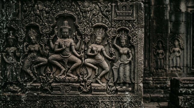 Ancient Khmer bas-relief carvings depicting dancers on a stone temple wall.