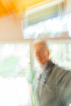 Man against window, motion blur