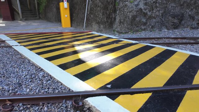 Yellow and Black Diagonal Hatch Road Markings at Railway Level Crossing