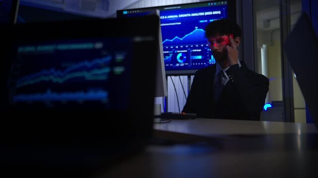 Business executive wearing smart glasses analyzing digital dashboards and business intelligence metrics in a modern office, demonstrating AI powered analytics and data driven decision making