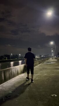 Man With Bicycle on a Nighttime Path