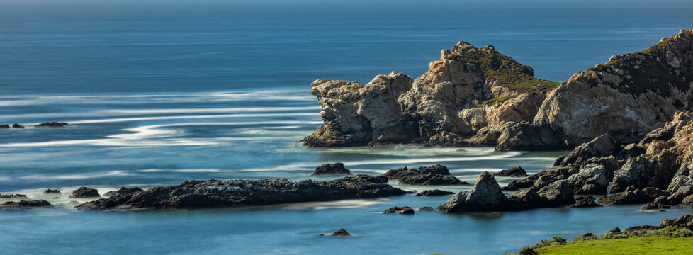 Water swirling around rocks, motion blur