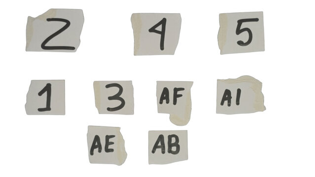 Assorted gray and white numbered and lettered square tiles