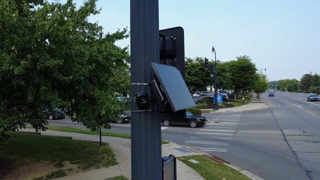 Flock safety police law enforcement license plate reader set up outside to help monitor traffic and catch vehicle speeders.